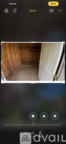 A white door is in a wooden room.