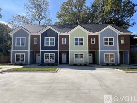 A row of houses with the first one on the left being blue and the rest being grey.