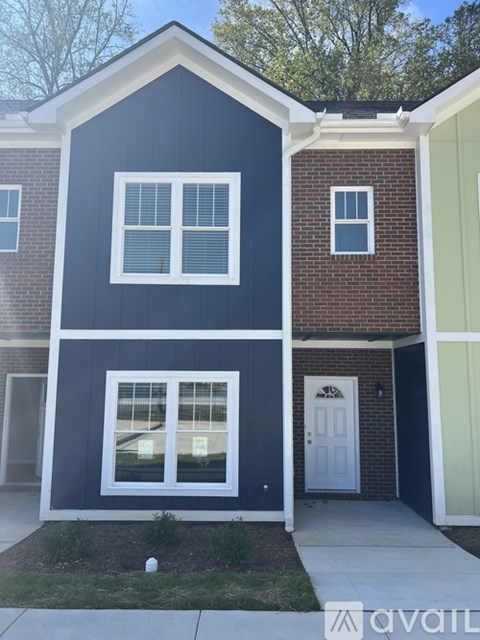 A house with a blue and white exterior and a white door.