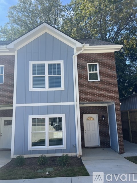 A house with a blue siding and a white door.