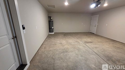 A spacious room with a carpeted floor and a white door.