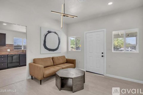 A living room with a brown couch and a white door.