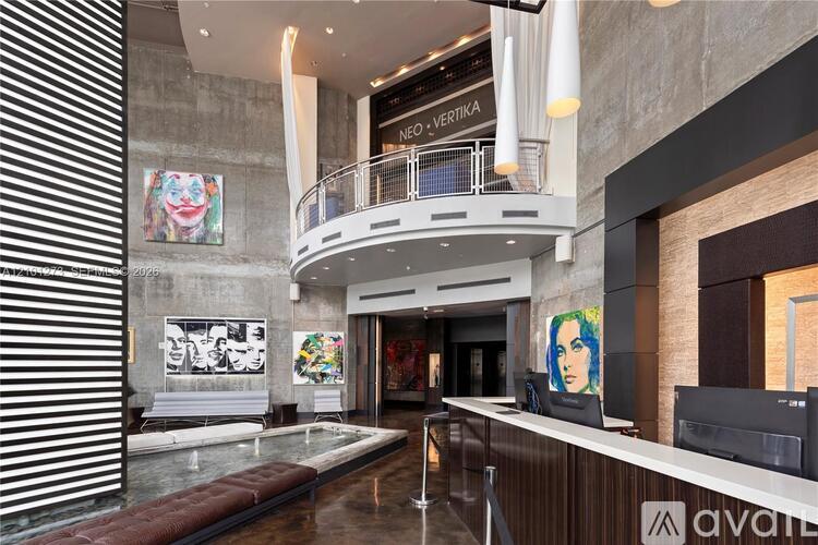 A reception area with a desk and a large painting on the wall.