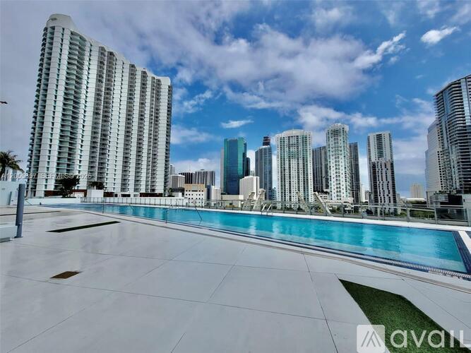 A large pool area with a view of a city skyline.