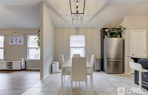 A kitchen with a table and chairs in the middle of the room.