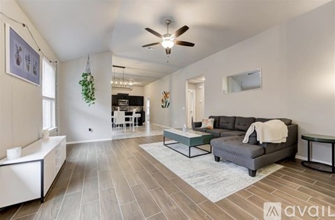 A living room with a grey couch and a white sofa.