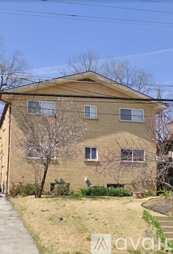 A brown building with a tree in front of it.