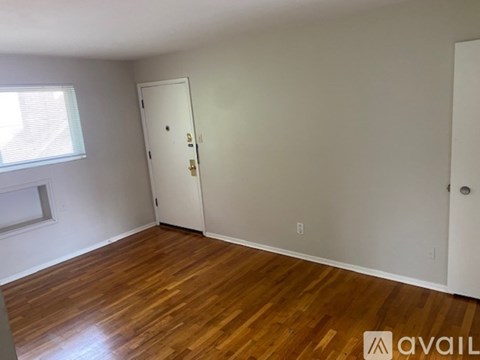 A room with wooden floors and a white door.
