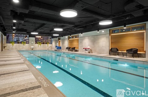 A large indoor swimming pool with the word "Swimming" written on the side.