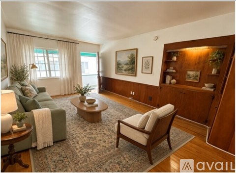 A living room with a couch, a chair, and a rug.