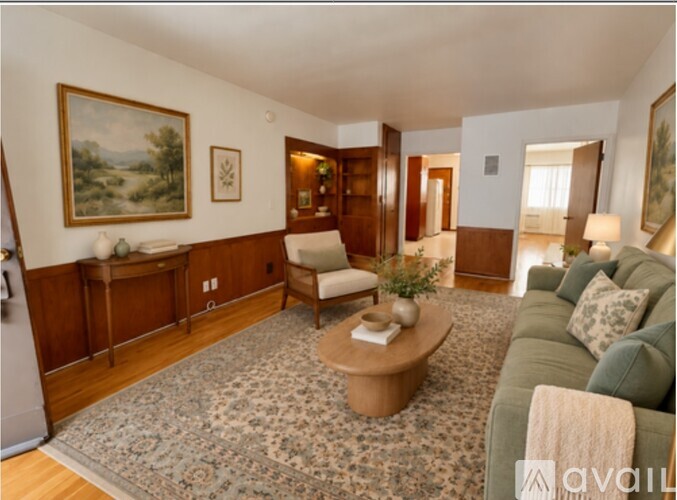 A living room with a couch, chair, and rug.