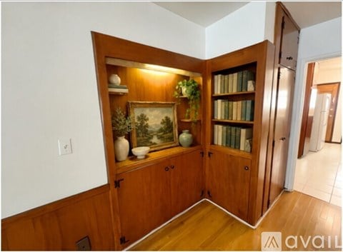 A room with a wooden cabinet and a painting on it.
