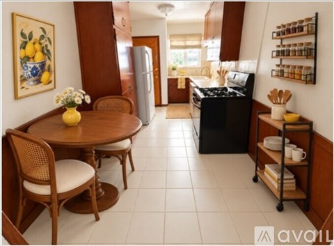 A kitchen with a table and chairs in the foreground and a refrigerator in the background.