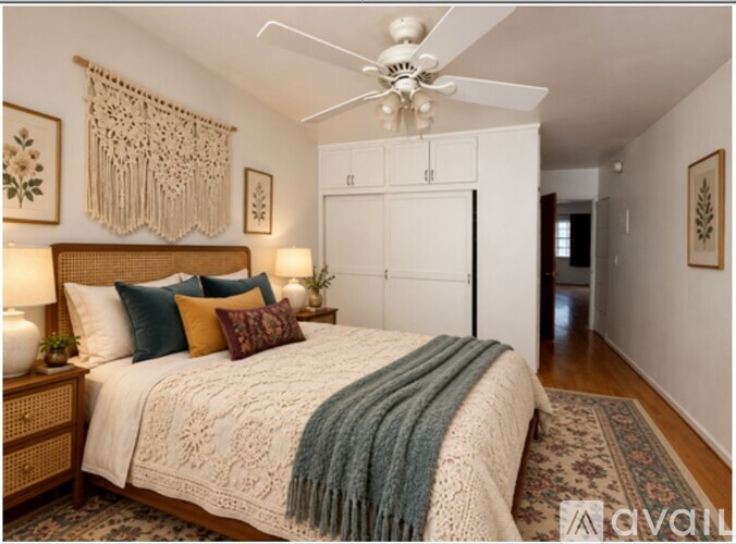 A bedroom with a bed, a ceiling fan, and a rug.