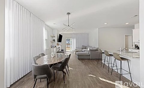 A modern dining room with a table set for six.