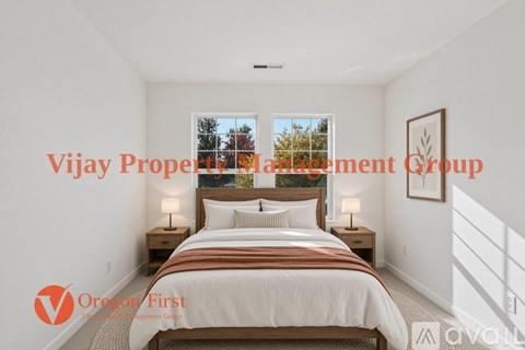 A bedroom with a large bed and a window overlooking trees.