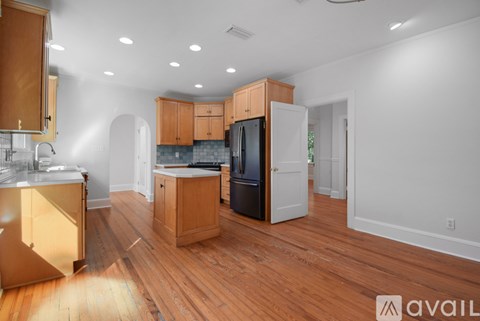A kitchen with wooden floors and cabinets is available for rent.