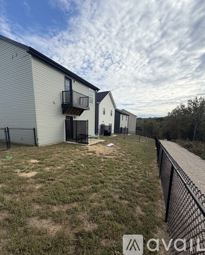 A row of houses with a grassy area in front.