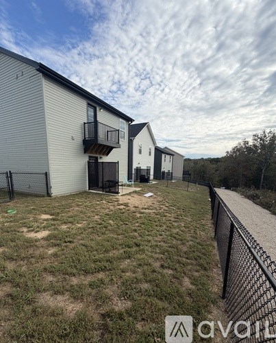 A row of houses with a grassy area in front.