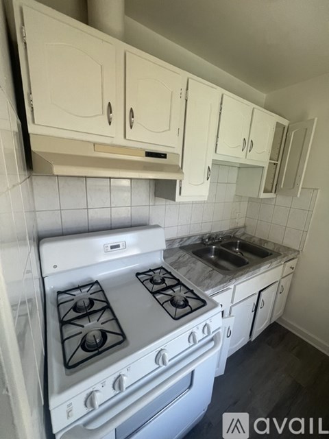 A kitchen with a stove and sink.