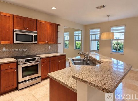A kitchen with wooden cabinets and granite countertops is available for rent.