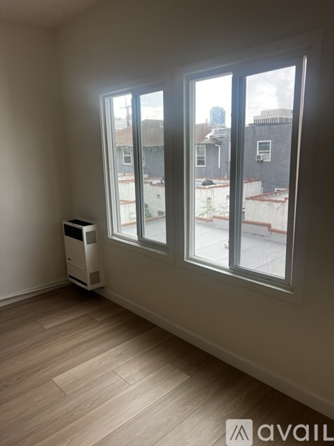 A room with a window and a floor heater.