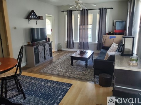 A living room with a television, a sofa, and a coffee table.