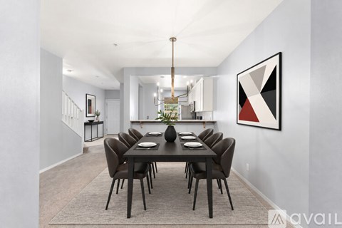 A dining room with a long table and chairs.