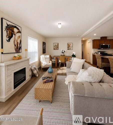 A living room with a fireplace and a painting of a horse on the wall.