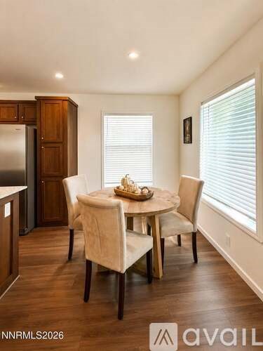 A dining room with a table set for four.