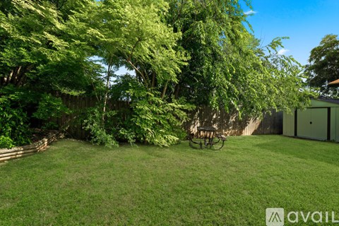 A backyard with a lawn and trees.