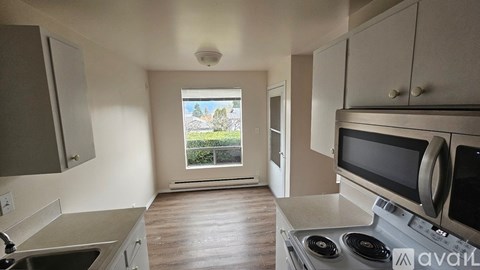 A kitchen with a stove top oven and microwave.