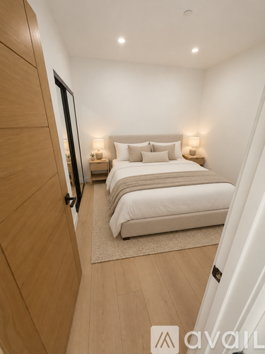 A bedroom with two beds and a wooden floor.