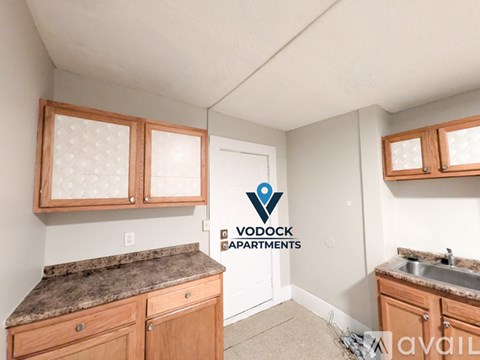 A kitchen with Vodock Apartments logo on the wall.