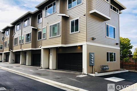 Apartment building with a parking lot in front.