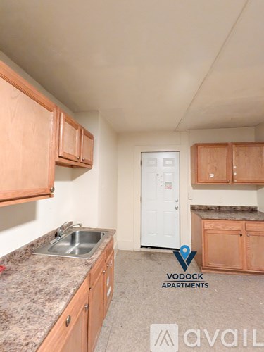 A kitchen with wooden cabinets and a granite countertop.