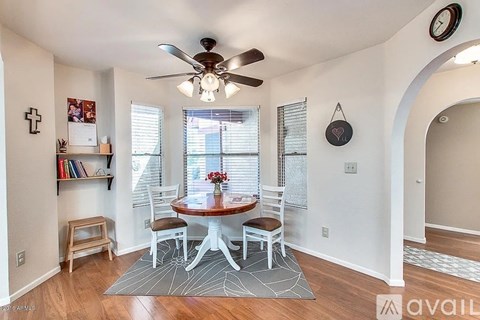 A dining room with a table and chairs.