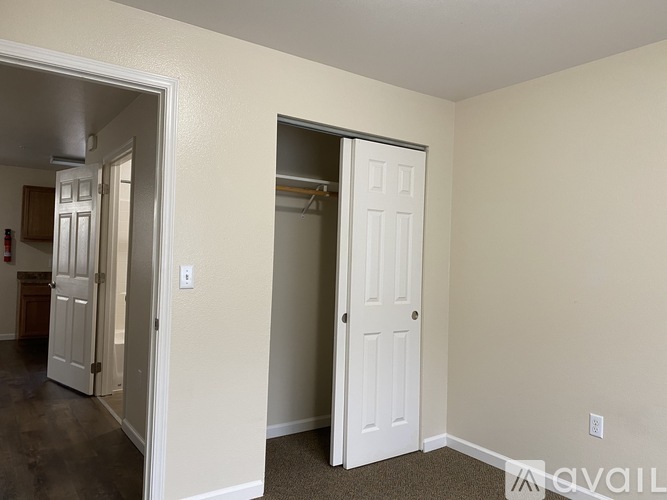 A room with a white door and a white wall.