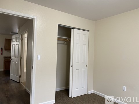 A room with a white door and a white wall.