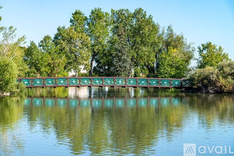 A bridge over a body of water with trees in the background.