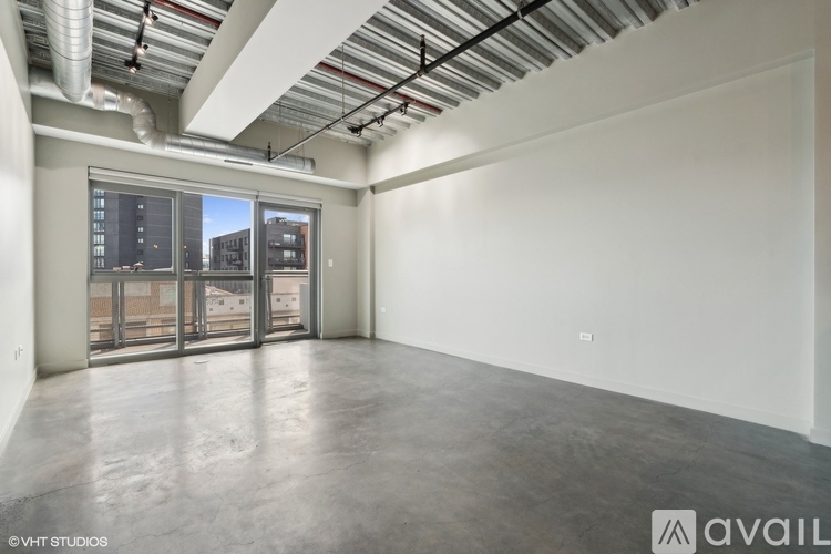 A large empty room with a view of the city through the windows.