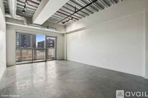 A large empty room with a view of the city through the windows.