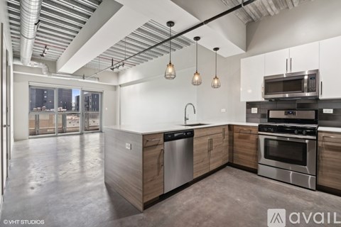 A modern kitchen with stainless steel appliances and wooden cabinets.