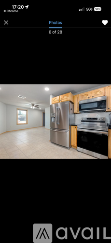 A modern kitchen with wooden cabinets and stainless steel appliances.