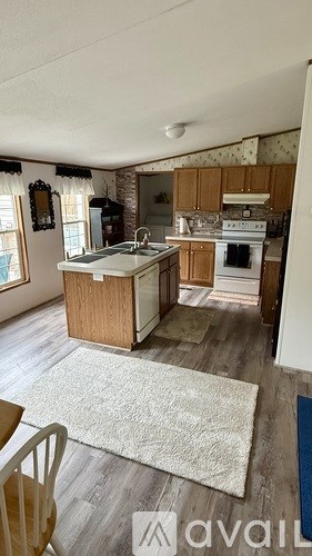 A kitchen with a white oven and wooden cabinets.