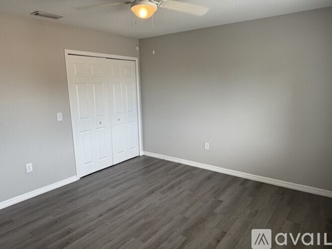 A room with a white door and grey walls.