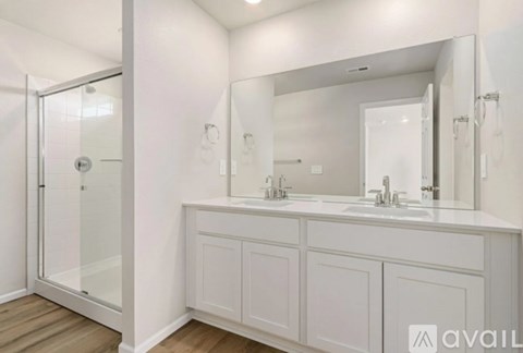 A bathroom with a white cabinet and a large mirror.