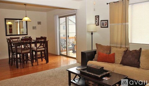 A living room with a couch, a dining table, and a coffee table.