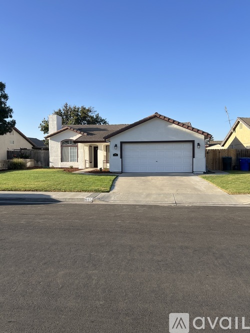 A house with a garage is for sale.
