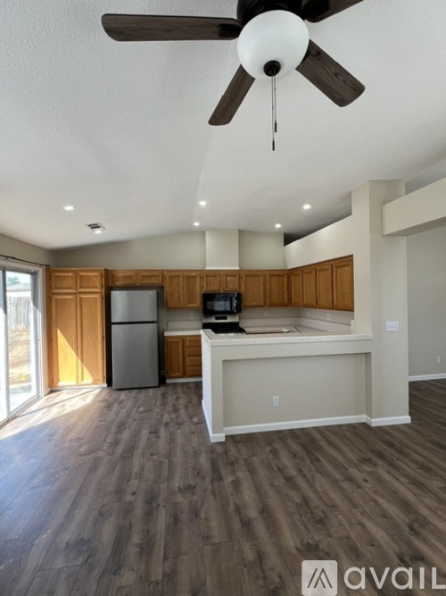 A modern kitchen with wooden cabinets and a white island.